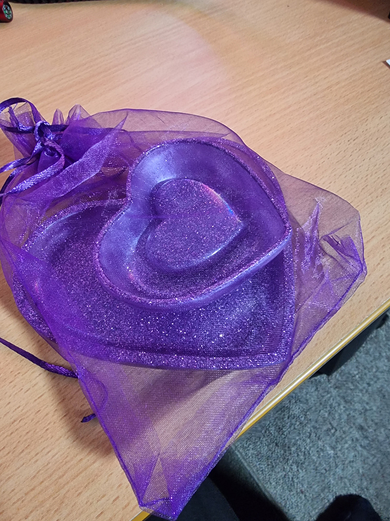 Handcrafted sparkling amethyst heart-shaped trinket dish nestled within a shimmering purple organza gift bag.