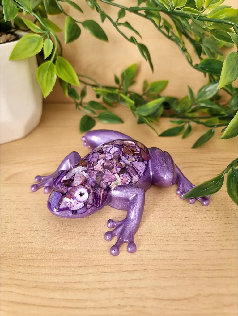A lustrous lavender resin frog sculpture is adorned with a mosaic of purple shell chips on its back and head.