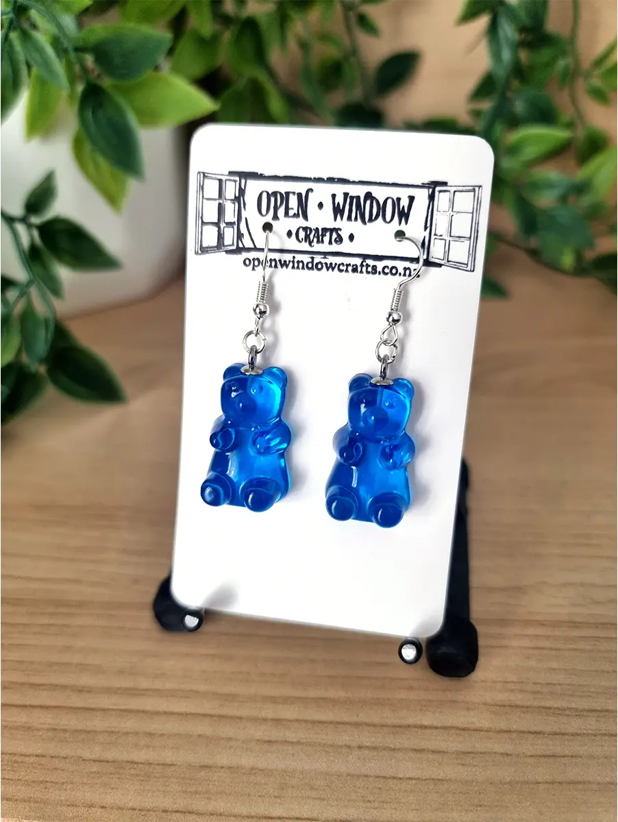 Blue gummy bear earrings shimmer with a translucent finish, crafted from handmade resin.