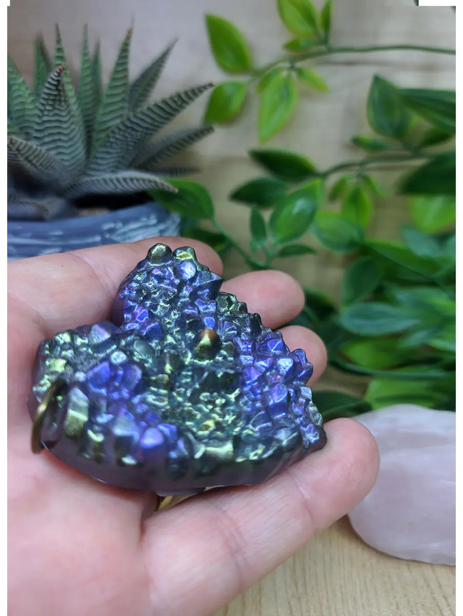 Iridescent blue and purple crystal heart pendant sparkles with metallic sheen.  Features a small golden bail.